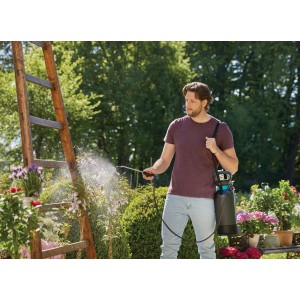 Muž používa postrekovač Gardena Comfort 5 l na ošetrovanie rastlín v záhrade.