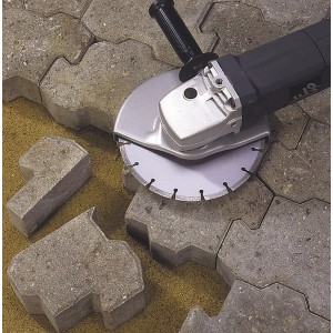 Diamantový kotúč LUX 125 mm na uhlovej brúske pri rezaní kamennej dlažby.