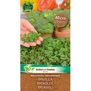 Balíček semien brokolice Microgreens: Mladé brokolicové klíčky v ruke, zelenina v pozadí.